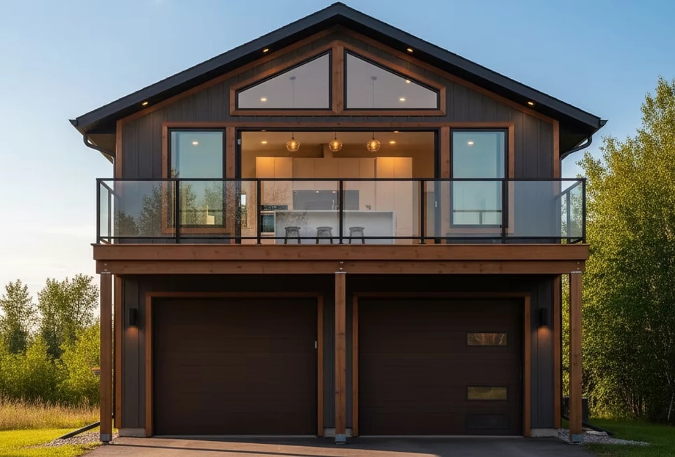 Carriage house with dark siding and cedar trim, a glass-railed balcony suite above a double garage